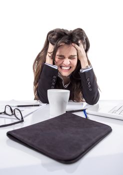 Portrait of stressed and frustrated young business woman pulling her hair over white background