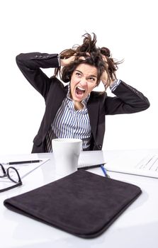 Portrait of crazy stressed young business woman screaming and pulling her hair over white background