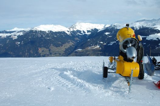 Yellow snow blower on the slope