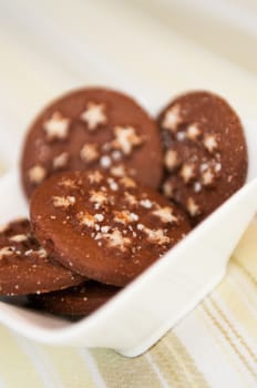 Detail of Christmas holiday dark chocolate cookies with white stars