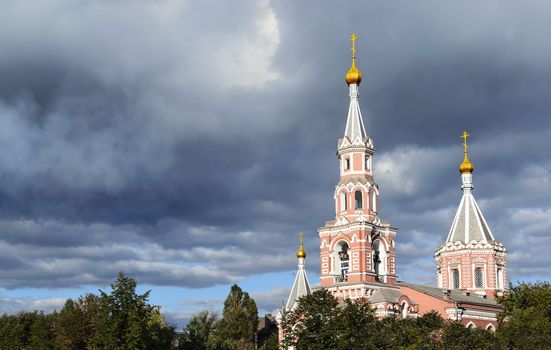 Christian church against the sky with dark clouds. Dniprodzerzhyns'k, Ukraine.