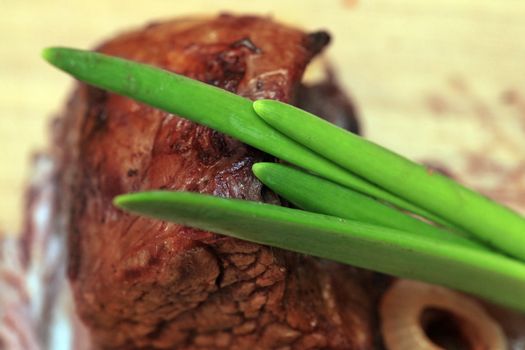 Roast red beef meat bbq bloc served on black plate with green chives