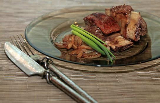 Roast red beef meat bbq bloc served on black plate with green chives