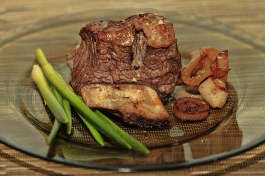 Roast red beef meat bbq bloc served on black plate with green chives