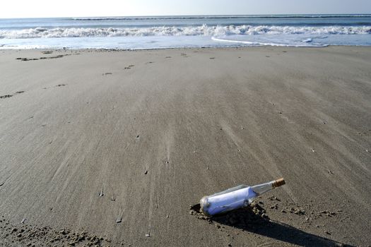 Bottle containing a message of help on a beach