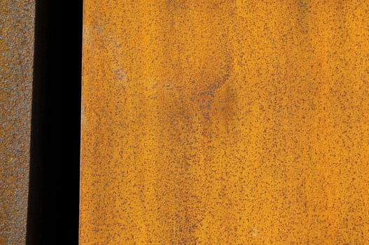 Orange Patterns on Rusty Surface of the Metal