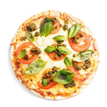 pizza with mozzarella, tomatos and green basil pesto isolated on white