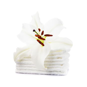 White towels with lily flower isolated on white