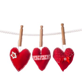 Sewed handmade red hearts on lace isolated
