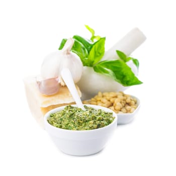 Pesto sauce ingredients: fresh green basil, parmesan, pine nuts and garlic. On white