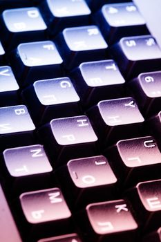 Black computer keyboard close up under lights