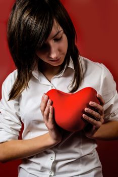 Teenage girl with red heart toy. Valentine's day concept. Give you my heart.
