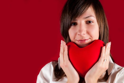 Teenage girl with red heart toy. Valentine's day concept. Give you my heart.