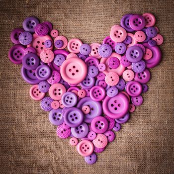 Heart shape from buttons over canvas textile