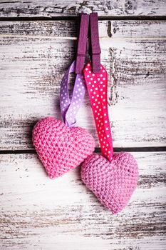 Crochet valentine hearts handing on the rope. Valentine's day greeting card. Love concept