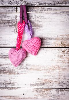 Crochet valentine hearts handing on the rope. Valentine's day greeting card. Love concept