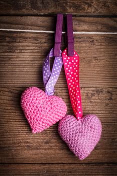 Crochet valentine hearts handing on the rope. Valentine's day greeting card. Love concept