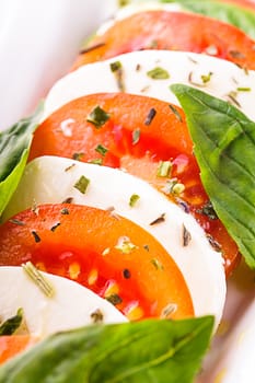 Caprese salad: slices of tomato and mozzarella cheese