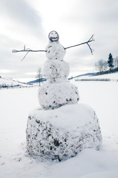 A snowman in the yard in village closeup