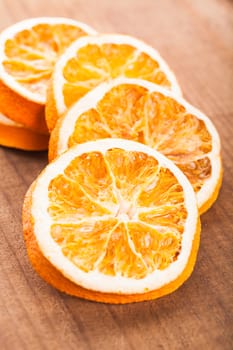 Dry orange slices on the wooden tabletop