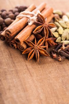 Collection of spices for mulled wine and pastry on the wooden table