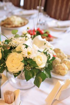 Flower decorations on the banquet table, prepared for event party or  wedding