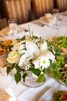 Flower decorations on the banquet table, prepared for event party or  wedding