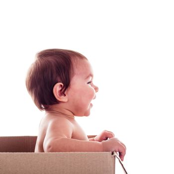 A small child (baby) in  the box isolated, side view