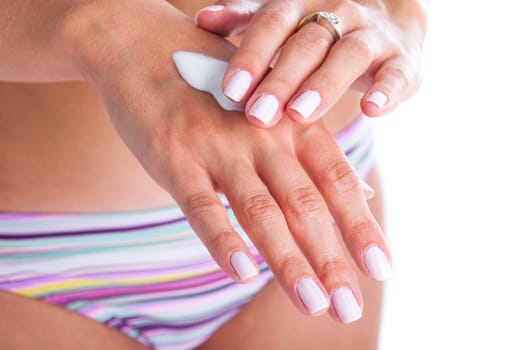 Woman is applaying moisturizing cream for hand care