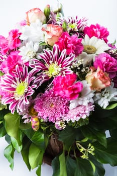 Pink flowers bouquet in a bowl isolated on white