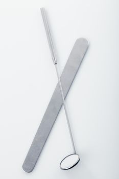 Medical instruments for ENT doctor: mirror and scapula for throat. Diagnostic concept