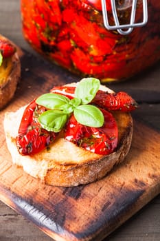 Bruschetta with sun dried tomatoes, basil leaves and garlic