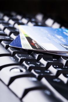 E-commerce, shopping on the internet, different credit cards on the keyboard