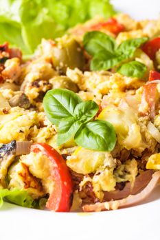 Omelet with vegetables and bacon on the plate