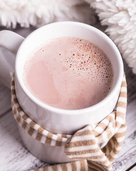 Warming drink - cup of cocoa with milk on the table