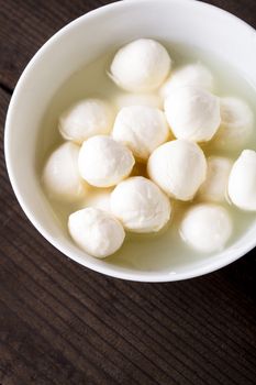 Fresh mozzarella cheese balls in a bowl