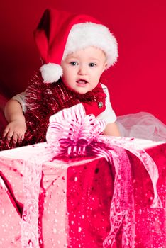 Baby in Santa hat on the red background