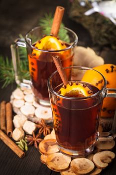 A mulled wine in the glass cup on wooden background