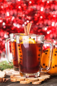 A mulled wine in the glass cup on wooden background