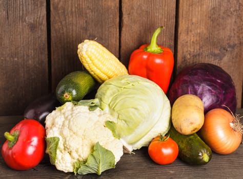 Still life of vegetables on the wood background closeup