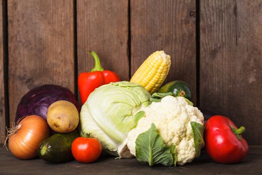 Still life of vegetables on the wood background closeup