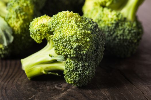 Green broccoli on the wood background closeup