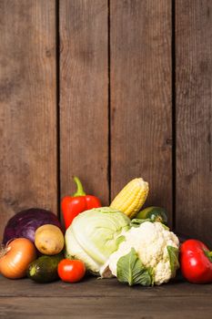 Still life of vegetables on the wood background closeup
