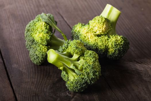 Green broccoli on the wood background closeup