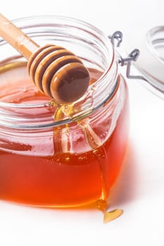Honey drip and jar on white backround