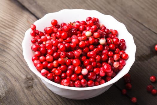 Cowberry in the bowl on the table