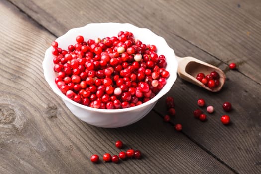 Cowberry in the bowl on the table