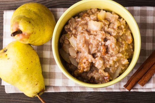 Oatmeal with pears and cinnamon on the linen napkin