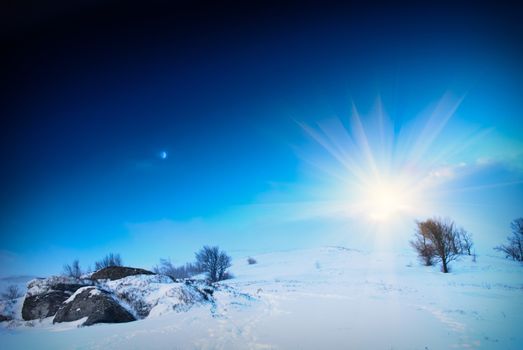 Winter snow mountain landscape with sun and moon