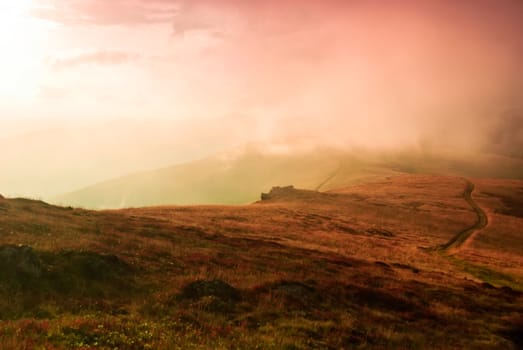 Autumnal hills high up in Carpathian mountains and sunrays